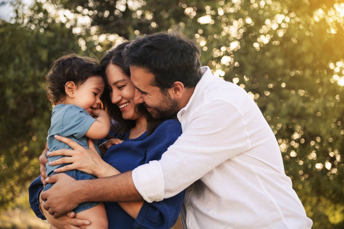 A joyful family moment with a father, mother and their one-year-old son