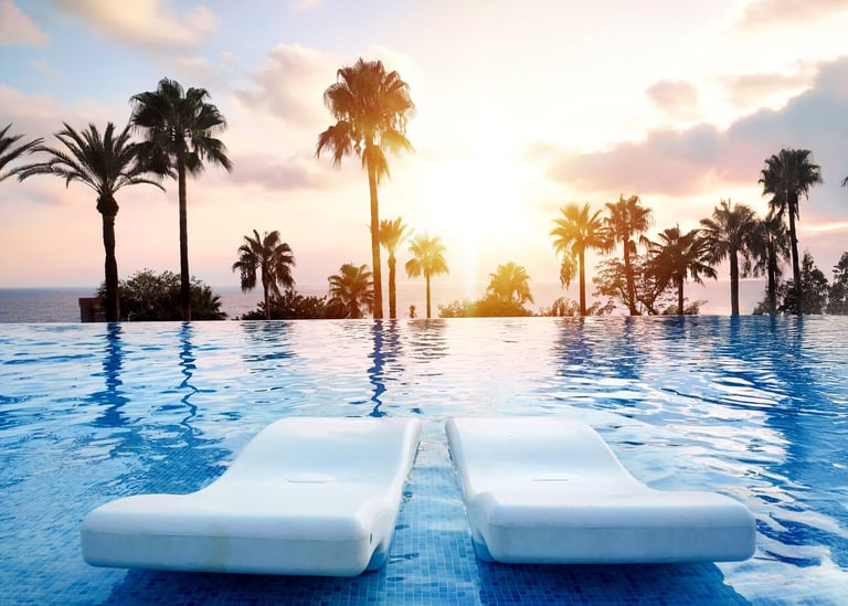 Luxury infinity pool with palm trees representing Dubai's opulent travel experience
